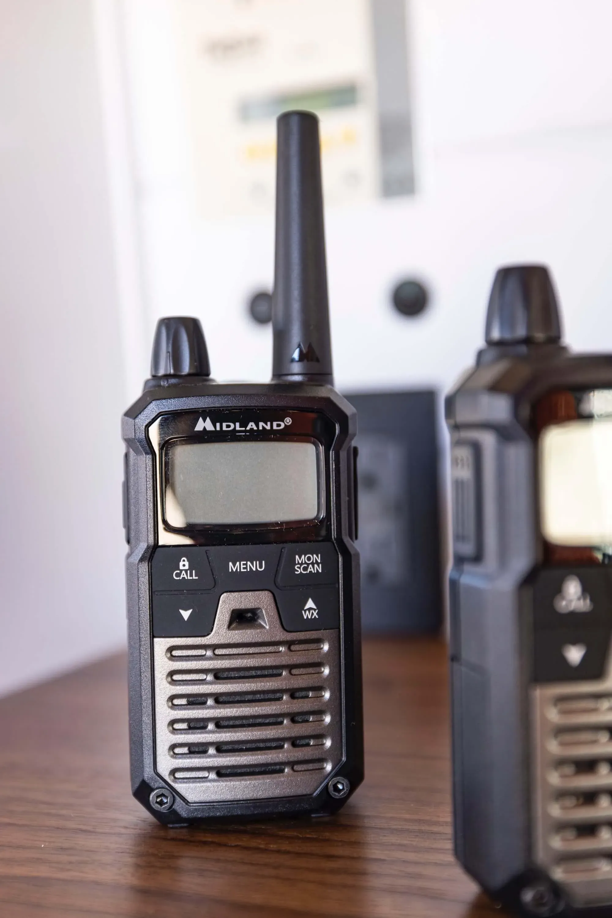 two walkie talkies sitting on top of a wooden table